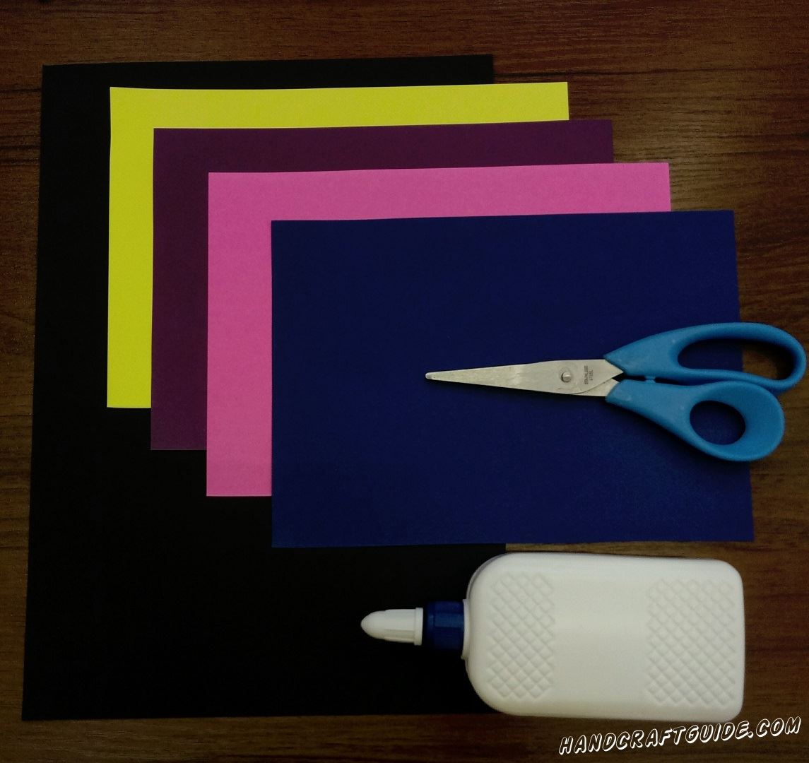 Для этого нам понадобится: Цветная бумага: чёрная, фиолетовая, синяя, розовая, желтая Ножницы Клей ПВА Фигурные ножницы