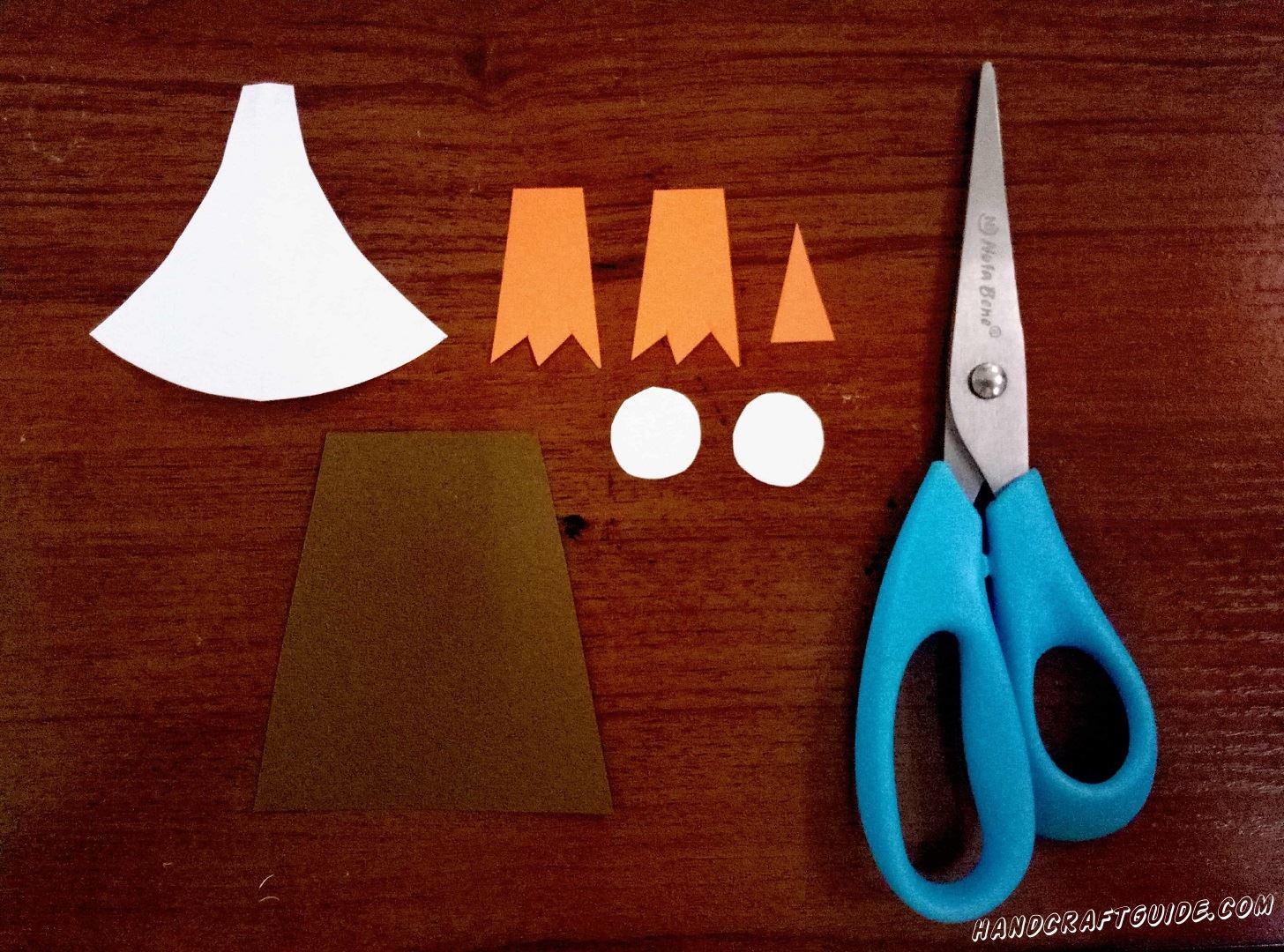 Cut out all necessary parts from black, white and orange paper.